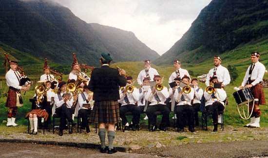 Jim Laughridge conducts the Blue Ridge Brass and Pipes. Standing in back: Joe Bailey, Kathi Graham, Ora Wells, Larry Sorkin, Tim Walker, Scott Elliott, and Fred Woodward.